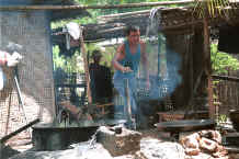 Jpeg 39K The head of the family of dyers blowing up the fire under the dye bath - Amarapura, Shan State 9809f18.jpg