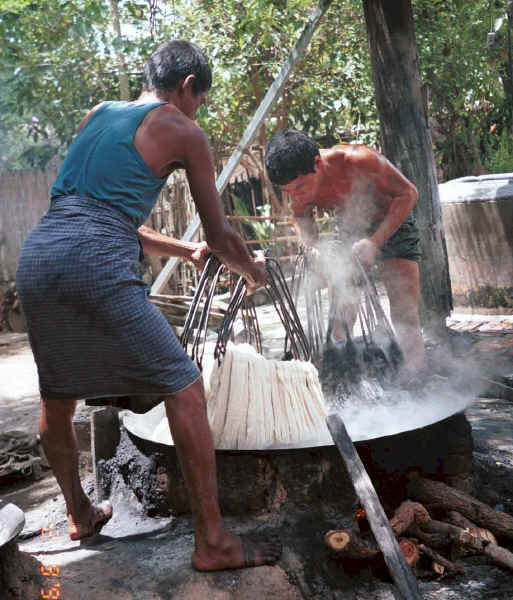 Jpeg K Plunging a second handful of fresh cotton hanks of thread into the dye bath - Amarapura, Shan State 9809g05.jpg