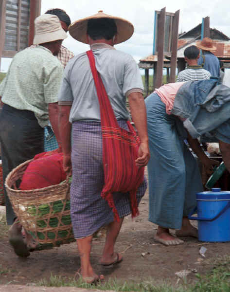 Men carry their purchases back to their boat wearing their longyis woven with indigo dyed thread - Nampan market, Lake Inle, Shan State 9809o19.jpg