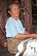 to 40K Jpeg 9809P02AE Intha woman with skeins of silk threads in her lap as she works on the early preparation stages of the threads in the ikat process at a weaving mill at Innbawkon (Inpawkhon) on Lake Inle, Shan State.