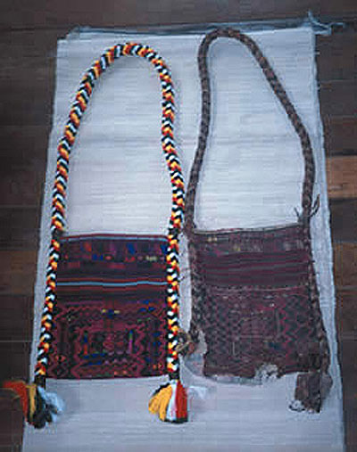 Jpeg 50K This photo shows two bags: on the left is a new man's bag, Jinghpaw Hkahku, woven by Gwi Kai Nan in Myitkyina, 2002. This was commissioned by the Green Centre at the Brighton Museum (UK) which, in 2001, commissioned weavers in Kachin State to make 17 wedding outfits. The bag on the right has been in Gwi Kai Nan's family for more than four generations. 