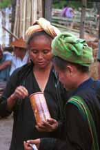 to 22K Jpeg 9809N07 Two Pa'O women examining a pottery jar at Nampan 5-day rotating market, Lake Inle, Shan State