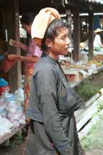 to 27K Jpeg 9809N21  Pa'O woman at Nampan 5-day rotating market, Lake Inle, Shan State. Note her short jacket with front pocket over her loose blouse with embroidery edging down the seams and her towelling headdress.