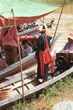 to 37K Jpeg 9809R35 Pa'O woman buying liquid fuel from a trader on one of the boats at Ywama floating market, Lake Inle, Shan State