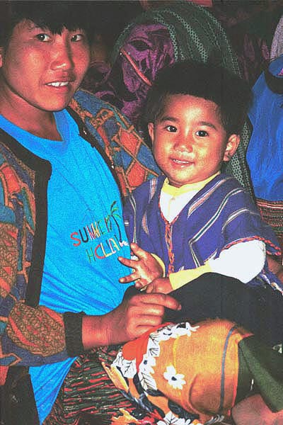 75K Jpeg Mother and small boy at the 'Full Moon day' prayers in the Buddhist temple in the Silver Palaung Pein Ne Bin village near Kalaw, southwestern Shan State.