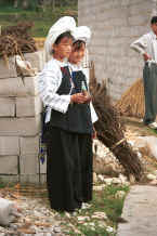 Jpeg 27K Two young Bouyei girls in their traditional costume welcoming us to the village with alcohol in gourd cups - Bi Ke village, Mi Gu township, Zhenfeng county, Guizhou province 0010r32.jpg