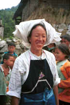 Jpeg 27K Bouyei woman against a background of school children - Bi Ke village, Mi Gu township, Zhenfeng county, Guizhou province 0010s15.jpg