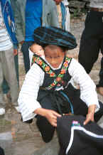Jpeg 29K Bouyei mother with her baby on her back spreading out an apron for sale - Bi Ke village, Mi Gu township, Zhenfeng county, Guizhou province 0010s22.jpg