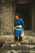 Jpeg 42K Miao woman coming our of her stone house - Chang Tion village, Cheng Guan township, Puding county, Guizhou province 0010w03.jpg
