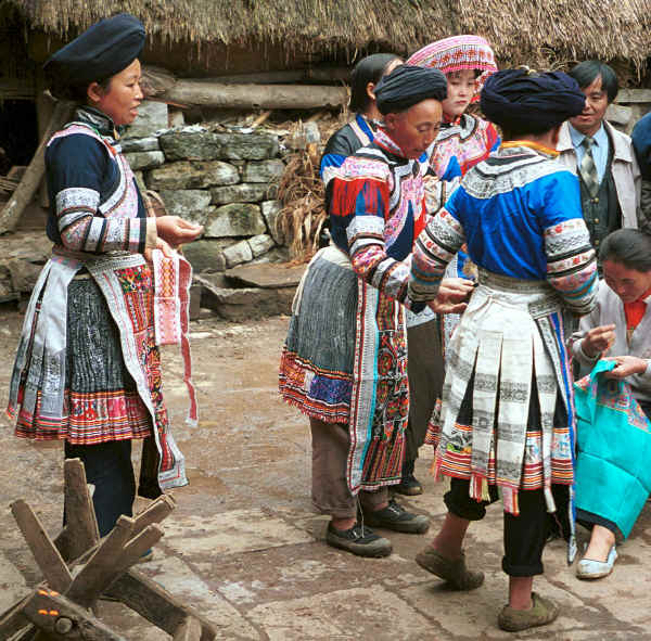 Miao women gathered outside houses showing off their embroidery skills - Chang Tion village, Cheng Guan township, Puding county, Guizhou province 0010w16.jpg