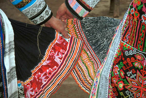 Miao women comparing their skirts - the black skirt on the left is hemp and the one on the right is ramie - Chang Tion village, Cheng Guan township, Puding county, Guizhou province 0010w17.jpg