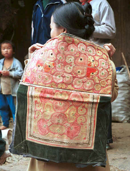 Miao baby embroidered baby carrier being show (looks Side Comb Miao in style) - Chang Tion village, Cheng Guan township, Puding county, Guizhou province 0010w29.jpg