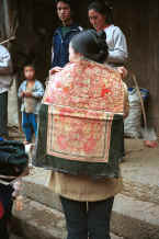 Jpeg 42K Miao baby embroidered baby carrier being show (looks Side Comb Miao in style) - Chang Tion village, Cheng Guan township, Puding county, Guizhou province 0010w29.jpg