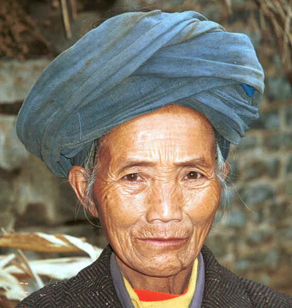 Miao woman - although she is wearing a manufactured coat her turban looks to be hand woven and hand dyed with indigo - Chang Tion village, Cheng Guan township, Puding county, Guizhou province 0010w32.jpg