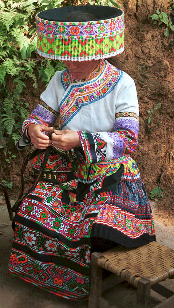 Working on a braid - the costume shows both Clean Water and Red Hat Miao - Da Shu Jia village, Xin Zhou township, Longlin county, Guangxi province 0010i07.jpg
