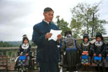 Jpeg 31K The village Secretary reading out a welcome and thanks to the Black Miao girls for dancing for us -  - Dai Lo village, Shi Zi township, Ping Ba county, Guizhou county 0010z19.jpg