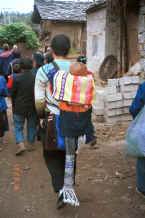 Jpeg 25K Black Miao father carrying his child through the village - Dai Lo village, Shi Zi township, Ping Ba county, Guizhou county 0010za09.jpg