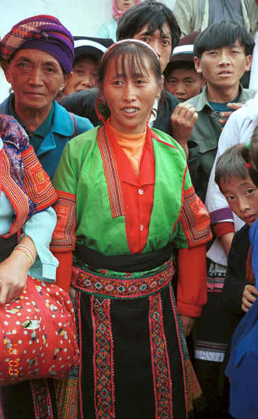 Red Hat Miao woman modelling a jacket which I had just bought from her - De Wo market, De Wo township, Longlin county, Guangxi province. 0010g06.jpg