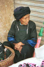 Jpeg 30K Selling handmade shoes at De Wo market.  Possibly a Bouyei old lady.  De Wo township, Longlin county, Guangxi province 0010g22.jpg