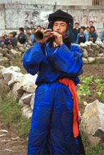 to Jpeg 51K 0110D15  Trumpeter blowing his welcome to Gan He village, Ya Rong township, Huishui county, Guizhou province, south-west China. Note the complex weaving of the ends of his head-cloth. The people living in this village are known as Qing Miao. There has been much intermarriage between Miao and Bouyei which is evident from the costume of the women.to Jpeg 51K 0110D15  Trumpeter blowing his welcome to Gan He village, Ya Rong township, Huishui county, Guizhou province, south-west China. The people living in this village are known as Qing Miao. There has been much intermarriage between Miao and Bouyei which is evident from the costume of the women.