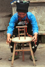 to Jpeg 53K  0110E04 Woman working on a briad loom in Gan He village, Ya Rong township, Huishui county, Guizhou province, south-west China. The people living in this village are known as Qing Miao. There has been considerable intermarriage between Miao and Bouyei and the costume is very mixed.
