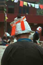 to Jpeg 41K 0111F28 Back of a Gejia woman showing her red-tassled headdress - Ma Tang village, Kaili City, Guizhou province