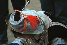 to Jpeg 57K 0111 A Gejia woman showing her headdress and part of her jewlery. The fabric is commercially printed to imitate the traditional wax resist designs of the Gejia. Ma Tang village, Kaili City, Guizhou province