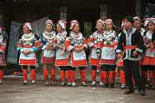 to Jpeg 57K 0111G09 Gejia dance troupe performing in Ma Tang village, Kaili City, Guizhou province in November 2001. The apparently wax resist fabric in their costume - at least the headdress, apron and sleeves of the blouse - are now generally made from commercially printed fabric which imitates the Gejia traditional wax resist designs. 