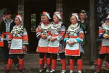 to Jpeg 56K 0111G17 Gejia dance troupe performing in Ma Tang village, Kaili City, Guizhou province in November 2001. The apparently wax resist fabric in their costume - at least the headdress, apron and sleeves of the blouse - are now generally made from commercially printed fabric which imitates the Gejia traditional wax resist designs. 