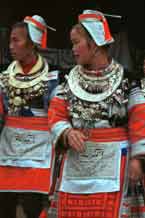 to Jpeg 55K 0111G19 Gejia dance troupe performing in Ma Tang village, Kaili City, Guizhou province in November 2001. The apparently wax resist fabric in their costume - at least the headdress, apron and sleeves of the blouse - are now generally made from commercially printed fabric which imitates the Gejia traditional wax resist designs 