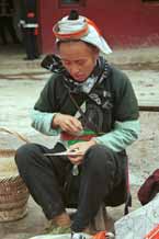 to Jpeg 59K 0111G34 Gejia women working on needle knitting the small net which is used to enclose the Gejia women's hair buns - a key part of their identifying headdress still being worn currently even when much of the rest of the costume has been exchange for western clothing. Ma Tang village, Kaili City, Guizhou province.