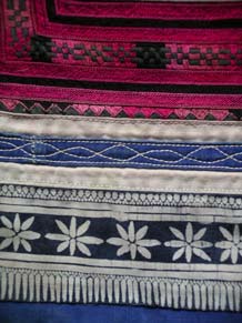 to Jpeg 55K MGP1302e  Detail of the bottom of an embroidered Ge Jia baby carrier collected by Pamela Cross in 2001 in Ma Tang village, Kaili city and which Andrew Dudley estimates is likely to be more than 20 years old. See his embroidered baby carrier which the seller estimated as between 30-40 years old.