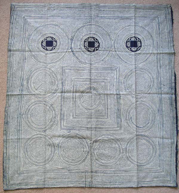 Jpeg 100K ge-jia12_wntrbc_pac  A Ge Jia winter baby carrier in the collection of Pamela Cross which was bought in Ma Tang village, Kaili city, Guizhou province in November 2001. (See photogallery of Ma Tang village.) It is worked on a single piece of yang bu (market bought machine made cotton). Andrew Dudley commented on the forum that "although this style is quite common and has been produced for a number of generations up to the present day, the pattern in the centres of the three large upper circles could be reasonably old, say about 60 years old, although it would be almost impossible to say for sure even if seeing the original piece (often, the centres of these circles were left blank as the tying band would cover this area)." 
