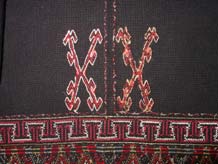 to Jpeg 65K Detail of embroidery on the back of a Qi Li woman's embroidered blouse purchased in 2005 in in the style of those from Changjiang in Hainan Island