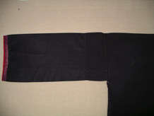 to Jpeg 50K Sleeve of a Qi Li woman's embroidered blouse purchased in 2005 in in the style of those from Changjiang in Hainan Island