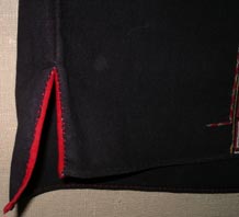 to Jpeg 56K Detail of side vent (with the front facing the camera) on a Qi Li woman's embroidered blouse purchased in 2005 in in the style of those from Changjiang in Hainan Island