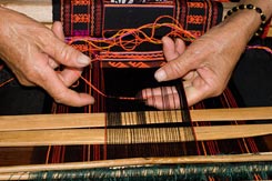 23K article on the June 2010 visit made by Chris Buckley to Hainan Island in search of Li weavers and weaving. On his return he sent in the travel notes below of weaving Li Minority "Brocade" (supplementary weft textile) of weaver Huang Ji Xiang, a member of the Qi subgroup of the Li people using a backstrap loom, in Shui Mian Qiao village near WuZhiShan on Hainan Island.