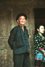Jpeg 33K Side comb Miao man and woman outside the door to their home - Long Dong village, De Wo township, Longlin country, Guangxi province 0010e05.jpg