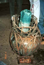 Jpeg 40K Side comb Miao - a roll of waxed cloth draining and oxidising (for about 10 minutes) over the indigo dye pot after its first of 12 dippings in the dye - Long Dong village, De Wo township, Longlin country, Guangxi province 0010f02.jpg