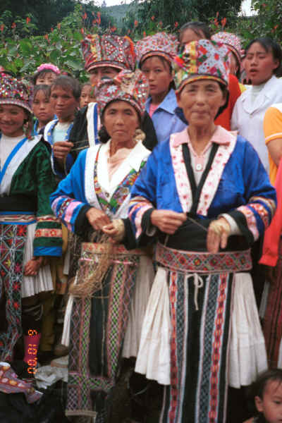 White Miao women splicing hemp as they displayed their textiles for sale in Ma Wo village, Zhe Lang township, Longlin county, Guangxi province 0010j29.jpg