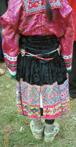 Back view of a White Miao woman showing her embroidered and beaded ties  - Ma Wo village, Zhe Lang township, Longlin county, Guangxi province 0010k08.jpg