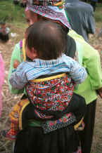 Jpedg 36K White Miao baby held in an embroidered  baby carrier, Ma Wo village, Zhe Lang township, Longlin county, Guangxi province 0010k09.jpg