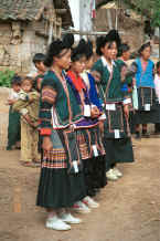 Jpeg 36K Side Comb Miao girls with two older women all in their festival finery - Pao Ma Cheng village, Teng Jiao township, Xingren country, Guizhou province 0010n08.jpg