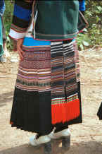 Jpeg 35K Back view of a Side Comb Miao girl's festival finery showing the hand woven ties of the apron - Pao Ma Cheng village, Teng Jiao township, Xingren country, Guizhou province 0010n12.jpg