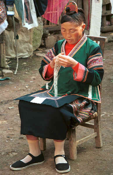 Side Comb Miao married woman cutting a paper cut for embroidery - Pao Ma Cheng village, Teng Jiao township, Xingren country, Guizhou province 0010n24.jpg