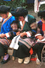 Jpeg 41K Side Comb Miao girls dressed their festival finery demonstrating embroidery for inserts in the top of their skirts - Pao Ma Cheng village, Teng Jiao township, Xingren country, Guizhou province 0010n26.jpg