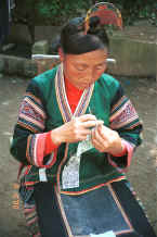 Jpeg 34K Side Comb Miao married woman finishing off a paper cut-out for embroidery probably for a sleeve insert - Pao Ma Cheng village, Teng Jiao township, Xingren country, Guizhou province 0010n27.jpg