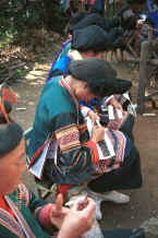 Jpeg 39K Side Comb Miao girls dressed their festival finery demonstrating embroidery for inserts in the top of their skirts - Pao Ma Cheng village, Teng Jiao township, Xingren country, Guizhou province 0010n29.jpg