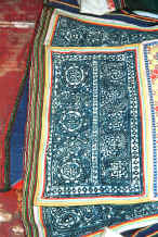 Jpeg 62K Side Comb Miao woman's jacket showing batik inserts and appliqued strip edgings.  These edgings have been applied by hand as can be seen from the back of the jacket showing at the bottom.  Pao Ma Cheng village, Teng Jiao township, Xingren country, Guizhou province. 0010o16.jpg