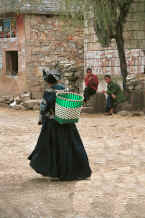 Jpeg 48K Old Bouyei woman walking through the village open area - Shitou village, Huanggousu township, Zhen Nin county, Guizhou province 0010u06A.jpg